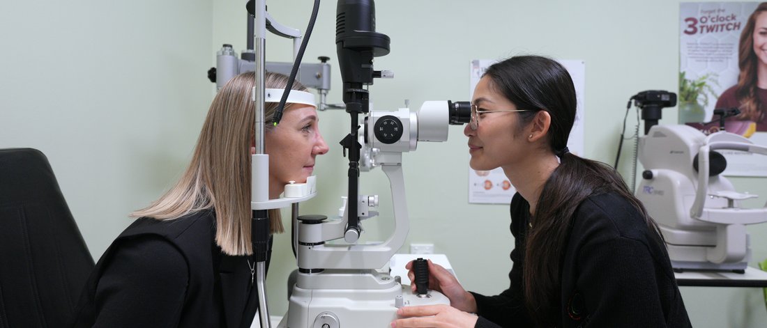 Optometrist Wendy Nguyen examining a patient at the slit lamp at Spectrum Family Eyecare